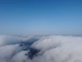 High above the thick fog, like beautiful ocean of clouds at sunrise. Sun is rising above the endless sea of clouds until Royalty Free Stock Photo
