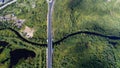 High aerial drone view of a bridge running through the dense forest