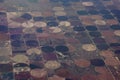 High aerial view of the crop circles created in farm fields by center pivot sprinklers
