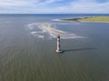 High aerial view of the Morris Island Lighthouse with Folly Beach in the background