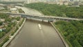 High altitude aerial shot of Moscow river tour boats, cars and metro bridge