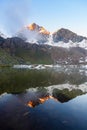 High altitude alpine lake in idyllic land with majestic rocky mountain peaks. Long exposure at dusk. Wide angle view on the Alps Royalty Free Stock Photo