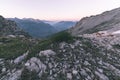 High altitude extreme terrain, rocky mountain peak and jagged ridge, with scenic dramatic stormy sky. Wide angle view in backlight Royalty Free Stock Photo