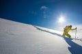 High altitude mountain explorer walking through deep snow