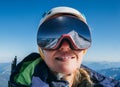 High altitude mountaineer smiling female portrait in safe ski helmet and goggles on the Mont Blanc 4810m with picturesque Alpine