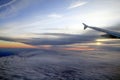 High Altitude Sunset over the Clouds from a Plane Window Royalty Free Stock Photo