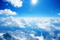 High Altitude View of Snow Covered Mountain Peaks and Expansive Cloudscape on a Sunny Day Royalty Free Stock Photo