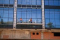 High-altitude work on the exterior walls on a glass building. Royalty Free Stock Photo