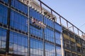 High-altitude work on the exterior walls on a glass building. Royalty Free Stock Photo