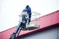 High-altitude works. Professional installation work on a construction building site. Assemblers perform high-altitude installation Royalty Free Stock Photo