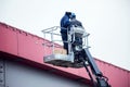 High-altitude works. Professional installation work on a construction building site. Assemblers perform high-altitude installation Royalty Free Stock Photo