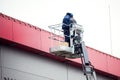 High-altitude works. Professional installation work on a construction building site. Assemblers perform high-altitude installation Royalty Free Stock Photo