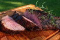 High angel view of grilled beef meat steaks on wooden cutting board .