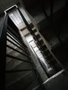 High angle above view down of old diry vintage staircase winding spiral with nobody, architecture dark low key abstract pattern. Royalty Free Stock Photo