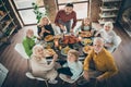 High angle above view photo of big family sit feast meals table roasted turkey father guy making slices multi-generation