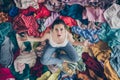 High angle above view photo of stressed helpless lady stay home spring cleaning household sit many clothes stack floor Royalty Free Stock Photo