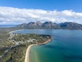 High angle aerial drone view of Coles Bay with Richardsons Beach and Hazards Mountain range Royalty Free Stock Photo