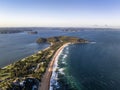High angle aerial evening drone view of Palm Beach and Barrenjoey Head and Lighthouse.