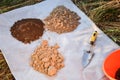 High angle arranged heaps of soil samples with garden tool outdoors