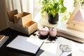 High angle on black desk with posters and pink vases in workspace interior with plant Royalty Free Stock Photo