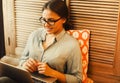 Happy young woman using laptop