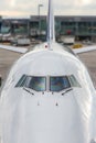 Close up of a jumbo jet nose, front view with windshield and wipers. Royalty Free Stock Photo