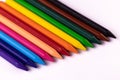 High angle close up shot of crayon color sticks put on white background placed laterally adjacent to each other