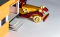 High angle close up shot of a vintage toy car parked behind a house made with craft materials Royalty Free Stock Photo