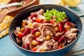 Bowl with appetizing tuna salad with canned beans and corn served on wooden table