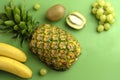 High angle closeup shot of assorted mixed fruits on a green background Royalty Free Stock Photo