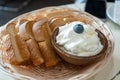 High angle closeup shot of french toast with a bowl of whipped cream