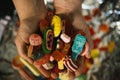 High angle closeup shot of a male`s hand holding delicious colorful gummy candies