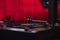 High angle closeup shot of a modern vinyl record player with a red background Royalty Free Stock Photo