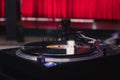 High angle closeup shot of a modern vinyl record player with a red background Royalty Free Stock Photo