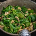 High angle closeup of a spinach mushroom salad in a bowl