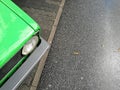 High angle closeup view of the headlights of an old vintage green car Royalty Free Stock Photo