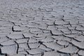 High angle greyscale shot of a cracked stony ground in a deserted area Royalty Free Stock Photo