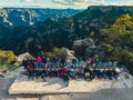 High-angle of a group of tourists taking a group photo in Creel with mountains in the background