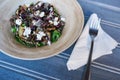 Healthy mixed vegetable salad with cutlery on a blue table Royalty Free Stock Photo