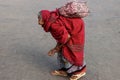 High-angle of hunchbacked old woman with a slapped bag walking alone outdoors Royalty Free Stock Photo