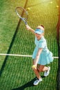 High angle image of a girl practicing serve on a brand new outdoor tennis court Royalty Free Stock Photo