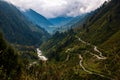 High-angle landscape view with roads on the forested mountain range, cloudy sky background Royalty Free Stock Photo