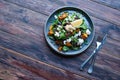 Delicious mixed vegetable salad sitting on a rustic wooden table Royalty Free Stock Photo