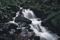 High angle long exposure view of water gushing down a creek in a forest Royalty Free Stock Photo