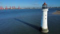 High-angle of the New Brighton lighthouse with the seascape, sunlit cityscape, clear sky background Royalty Free Stock Photo