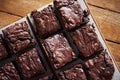 Stacks of homemade chocolate brownies sitting on a cafe table