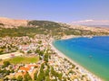 High-angle of a populated beach Croatia with trees and houses, clear and sunlit sky background