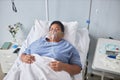 Black senior woman laying on bed in hospital room Royalty Free Stock Photo