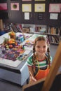 High angle portrait of girl painting on canvas Royalty Free Stock Photo