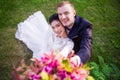 High angle portrait of happy wedding couple on grassy field Royalty Free Stock Photo